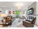 Inviting living room with modern fireplace, stylish furniture, and sliding glass doors to the outside at 3612 Wyandot St, Denver, CO 80211