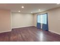 Bright living room featuring hardwood floors, neutral walls, recessed lighting, and a large window at 5344 Wheeling St, Denver, CO 80239