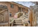 A charming brick home with wooden steps leading to the front door at 17306 W 17Th Pl, Golden, CO 80401