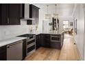 Modern kitchen featuring custom cabinets, stainless steel appliances, and a spacious island at 3142 W 26Th Ave, Denver, CO 80211