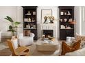 Elegant living room featuring built-in bookcases, a fireplace, and stylish, comfortable seating at 3142 W 26Th Ave, Denver, CO 80211