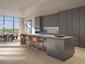 Modern kitchen boasts a large island with seating, sleek cabinets, and stainless steel appliances at 185 N Steele St # 204, Denver, CO 80206