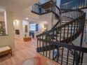 Open foyer featuring hardwood floors, a curved staircase, and views to kitchen at 5845 W Mansfield Ave # 259, Denver, CO 80235