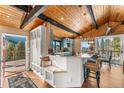 Bright, stylish kitchen featuring blue cabinets, modern appliances, a breakfast bar, and scenic views at 32094 Christopher Ln, Conifer, CO 80433