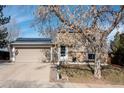 Tan two-story home showcasing solar panels and an attached two-car garage at 3971 S Quintero Way, Aurora, CO 80013