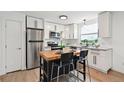 Modern kitchen featuring stainless steel appliances, granite countertops, and a butcher block island at 9366 Clermont Dr, Thornton, CO 80229