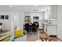 Open floor plan showcases the modern kitchen and comfortable living space with neutral decor at 9366 Clermont Dr, Thornton, CO 80229
