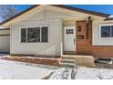 Inviting front entrance with modern white door and brick accents at 994 S Vivian Ct, Lakewood, CO 80228