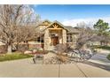 Charming home exterior with stone pillars, wood accents, and a landscaped walkway at 501 Young Cir, Castle Rock, CO 80104