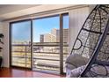 View from the balcony showcasing the city skyline and a unique hanging chair perfect for relaxing at 100 Park W Ave # 304, Denver, CO 80205