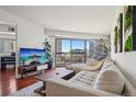 Cozy living room featuring stylish decor, a comfortable sofa, and a sliding glass door that leads to the balcony at 100 Park W Ave # 304, Denver, CO 80205