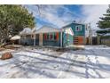 Beautiful blue two-story home featuring updated wooden garage door and colorful window shutters at 1120 Hartford Dr, Boulder, CO 80305