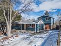 Charming blue two-story home with lovely landscaping and a large driveway, perfect for Gathering and guests at 1120 Hartford Dr, Boulder, CO 80305