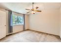 Bright bedroom featuring a ceiling fan, neutral walls, and large window at 13265 Raritan St, Denver, CO 80234