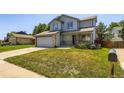 Inviting two-story home with a front porch and a spacious front yard at 13265 Raritan St, Denver, CO 80234