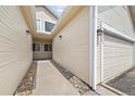 Exterior shot of a walkway and the side of the house leading towards the front door at 228 Quari St, Aurora, CO 80011