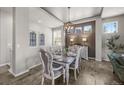Elegant dining room with wood floors, stylish lighting, and seating for six at 3429 Goodyear St, Castle Rock, CO 80109