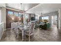 Open-concept dining room with modern chandelier, leading into a cozy living area at 3429 Goodyear St, Castle Rock, CO 80109