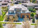 An eye-level aerial view of a two story home with solar panels and a backyard patio at 2136 S Juniper St, Lakewood, CO 80228