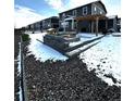 Backyard patio featuring a stone fire pit, a built-in barbeque area, and a pergola at 7435 E 159Th Pl, Thornton, CO 80602