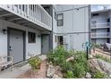 Close up of a condo building's exterior entrances with small rock garden, building numbers 103 and 104 at 1901 Clear Creek Dr # F104, Georgetown, CO 80444