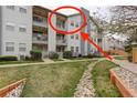 Exterior view of the condo building, showing the well-maintained lawn and partial view of a private balcony at 12281 E Tennessee Dr # 302, Aurora, CO 80012