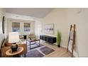 Bright living room with a vaulted ceiling, light wood floors, and neutral-colored walls creates a calm atmosphere at 12281 E Tennessee Dr # 302, Aurora, CO 80012