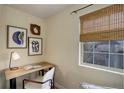 Cozy room featuring a wooden desk, comfortable chair, decorative artwork, and a window with natural light for workspace at 12281 E Tennessee Dr # 302, Aurora, CO 80012