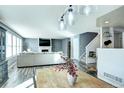 Bright living room with a fireplace, neutral walls, and wood-look flooring at 1130 Cardinal Ave, Brighton, CO 80601