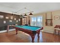 Spacious game room with a pool table, overhead lighting, dark accent wall, and access to a balcony at 7040 E Girard Ave # 406, Denver, CO 80224