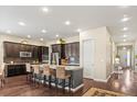 Spacious kitchen with granite countertops, stainless steel appliances, and a large center island at 7790 S Queensburg Way, Aurora, CO 80016