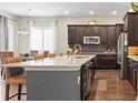 Bright kitchen with a granite island and stainless steel appliances at 7790 S Queensburg Way, Aurora, CO 80016