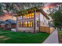 This home boasts a brick and siding exterior, fenced yard, and beautiful architectural details at 2391 Hudson St, Denver, CO 80207