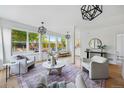 Spacious living room with large windows, contemporary decor, and a neutral color palette at 2391 Hudson St, Denver, CO 80207