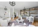 Cozy living room featuring stylish light fixtures, built-in shelving and comfortable seating at 2391 Hudson St, Denver, CO 80207