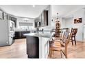 Charming eat-in kitchen featuring dark cabinetry, granite countertops, and stainless steel appliances at 56375 E 22Nd Pl, Strasburg, CO 80136