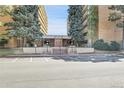 The building's facade has a tidy parking area, a neat brick entryway, and verdant bushes all around at 8060 E Girard Ave # 311, Denver, CO 80231