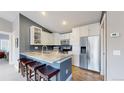 Modern kitchen with stainless steel appliances, white cabinets, and granite counters at 18274 W 58Th Pl # 37, Golden, CO 80403
