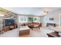 Inviting living room features a cozy fireplace and lots of natural light at 18274 W 58Th Pl # 37, Golden, CO 80403