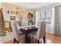 Formal dining room featuring hardwood floors, large bay window, and stylish decor at 13106 W Chenango Ave, Morrison, CO 80465