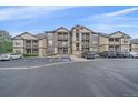 Attractive condo building with a parking lot and balconies on a sunny day at 7413 S Quail Cir # 1435, Littleton, CO 80127