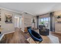 A cozy living room featuring modern decor, wood floors, and a sliding glass door to the balcony at 7413 S Quail Cir # 1435, Littleton, CO 80127