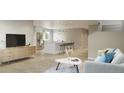 Open-concept living area with modern decor and seamless flow to the kitchen at 9061 E 14Th St, Aurora, CO 80010