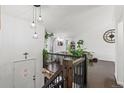 Inviting entryway with wooden staircase, modern lighting, and bright, open floor plan at 19792 E Bates Dr, Aurora, CO 80013