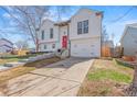 Stylish two-story home with a white exterior, driveway, and manicured lawn at 19792 E Bates Dr, Aurora, CO 80013