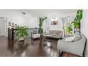 Bright living room with hardwood floors, neutral furniture, and large windows at 19792 E Bates Dr, Aurora, CO 80013
