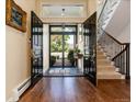 Grand entryway featuring double doors, hardwood floors, and staircase bathed in natural light, giving a bright, welcoming feel at 2552 E Alameda Ave # 16, Denver, CO 80209