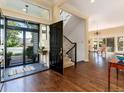 Inviting entryway with hardwood floors, stairs, and natural light streaming through the front door and sidelight windows at 2552 E Alameda Ave # 16, Denver, CO 80209