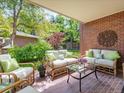 Cozy brick patio area with comfortable seating, lush landscaping, and decorative accents at 2552 E Alameda Ave # 16, Denver, CO 80209