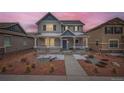 Charming two-story home with a covered front porch and landscaped front yard at 668 Sage Forest Ln, Monument, CO 80132
